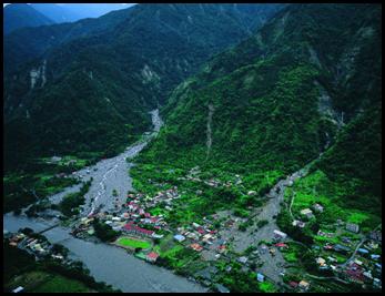 Fig. 4. Debris flows occurred at Songhe, Taichung County, caused by Typhoon Mindulle in July 3, 2004. About 40 houses were buried or severe damaged by the debris flows, but fortunately, only two people were killed by the debris flows due to successful warning and evacuation. 
